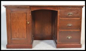 A 1920's large mahogany twin pedestal desk with a bank of drawers to one pedestal, locker cupboard