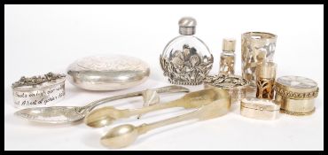 A collection of silver and silver white metal items to include scent phials, small scent funnels,