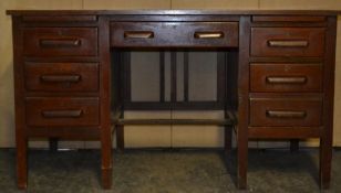 A vintage mid 20th century oak air ministry industrial twin pedestal desk having an arrangement of