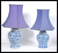 A pair of Chinese blue and white hand painted ceramic vases of large form being later converted to