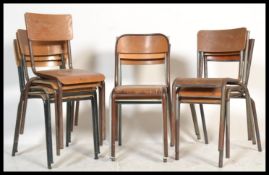 A collection of vintage retro 20th Century stacking chairs of tubular form having wooden panel seats
