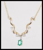 A hallmarked 9ct gold necklace having a fine rope twist chain with central faceted green stone and