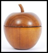A 20th wooden tea caddy in the form of an apple having a lead lined interior. Measures 11cm high