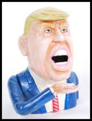 A novelty Donald Trump vintage style cast iron money box. Hand painted, with notation to verso.