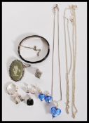 A selection of silver jewellery to include a stamped 925 silver necklace with a heart shaped glass