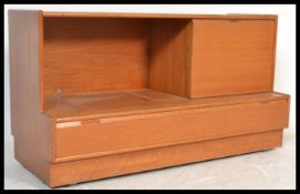 A retro 20th century teak wood side - low cabinet of Danish influence having an inset plinth base