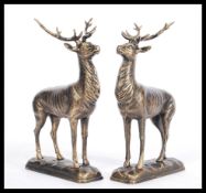 A pair of 20th century bronze effect cast iron statues / figures of deer. Standing, with antlers