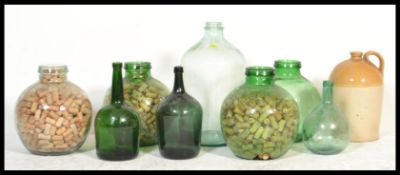 A collection of vintage 20th century acid glass carboys - bottles of large form some filled with