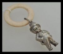 A 19th Century Victorian silver plate childs rattle in the form of a boy in a top hat and tails