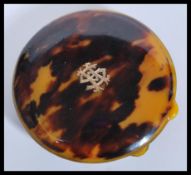 A vintage 20th century faux tortoiseshell compact