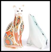 A Royal Crown Derby Imari paperweight in the form of a cat having a silver stopper along with a