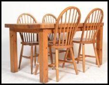 A 20th century antique style pine farmhouse dining table of rectangular form with thick plank top