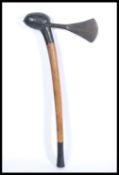 A vintage 20th Century African tribal hand axe with a shaped blade and turned stem with ebonised