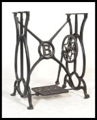 A Victorian mahogany and cast iron Singer sewing machine treadle table base having an excellent