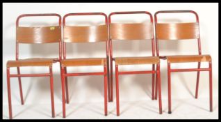 A set of 4 Remploy vintage mid 20th century church / village hall stacking chairs. With red