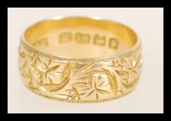A 19th Century Victorian hallmarked 18ct gold band ring with floral engraving. Hallmarked Birmingham