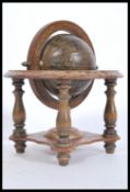 A vintage 20th Century desk globe antique style desk globe raised on a stained wood gimbal stand