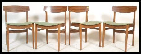 A set of four vintage retro 20th Century Remploy beech dining chairs raised on beech supports with