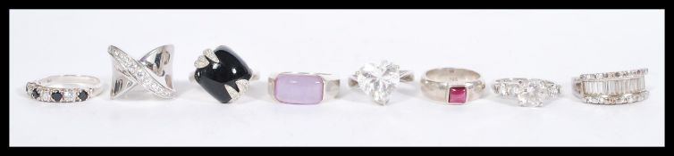 A selection of ladies 925 silver rings to include a crossover ring set with white stones, a ring set
