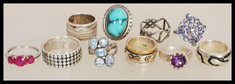 A group of ten sterling silver rings to include band ring with disc pattern, split band ring,