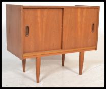 A mid century retro Danish influence teak wood pedestal record cabinet - sideboard being raised on