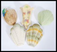 A collection of early 20th century wall pockets to include 2 Shorter & Son shell pockets, a Sylvas