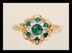 A hallmarked 9ct gold cluster ring set with green and white stones. Hallmarked Birmingham 1979.