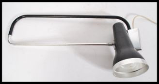 A mid century wall mounted adjustable angle poise desk lamp with pendant shade and chrome and