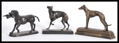 A collection of 3x cast iron bronze effect figures of dogs. Including one of hunting form, all on