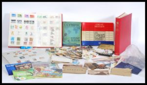 A large quantity of mixed stamps to include an album of Great Britain commemorative stamps,