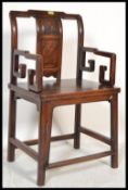 A 19th century Chinese elm elbow chair - armchair with carved figural detail to the back splat,