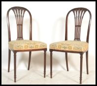 A pair of early 20th Century Edwardian mahogany dining / bedroom chairs in the manner of