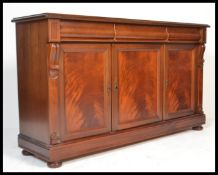 A good Victorian style mahogany sideboard being raised on a plinth base with bun feet having a