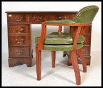 An antique Georgian style mahogany twin pedestal office desk having pedestals, each with banks of