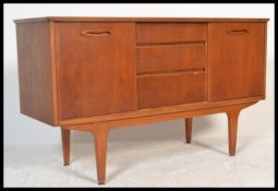 A retro 1970's small proportion teak sideboard raised on tapered legs with sliding door cupboards