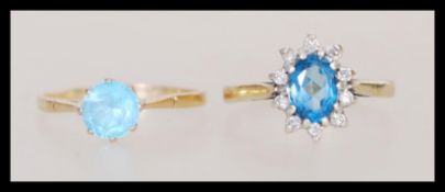 Two hallmarked 9ct gold rings one having a central faceted blue stone with a halo of white stones.
