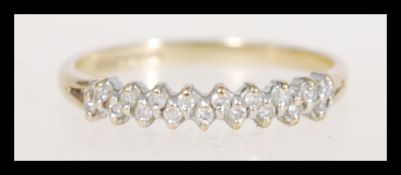 A hallmarked 9ct gold ring prong set with white stones. Hallmarked London (date mark rubbed).