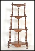 A 19th century Victorian mahogany and marquetry inlaid whatnot etagere having turned column supports