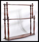 A 19th Century Victorian mahogany set of graduating wall shelves of waterfall shape with turned