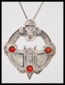 A silver hallmarked pendant necklace having a round silver pendant with Scottish Celtic design set