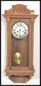 An early 20th Century Edwardian Vienna style oak cased wall clock, silvered dial, Roman numeral