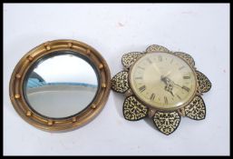 A 20th Century Metamec wall clock having a round face with a brushed yellow metal interior, having