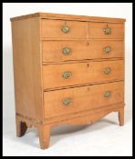 A 19th century Victorian oak chest of drawers being raised on French kick legs with a