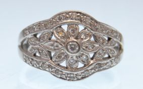 A HALLMARKED 18CT WHITE GOLD DIAMOND FLOWER HEAD RING.