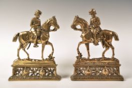 A PAIR OF VICTORIAN 19TH CENTURY BRASS LORD ROBERTS DOOR STOPS
