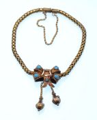 A Victorian gold and turquoise bracelet. The bracelet having a fancy snake link chain with bow
