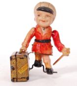 CHARMING RARE ALPS MADE TINPLATE CELLULOID LUGGAGE BOY CLOCKWORK