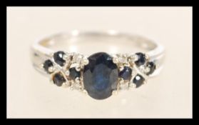 A hallmarked 9ct white gold diamond and sapphire r