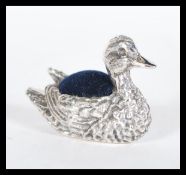 A sterling silver novelty pincushion in the form o