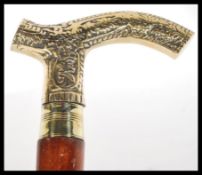 A malacca walking stick having a brass hooked hand